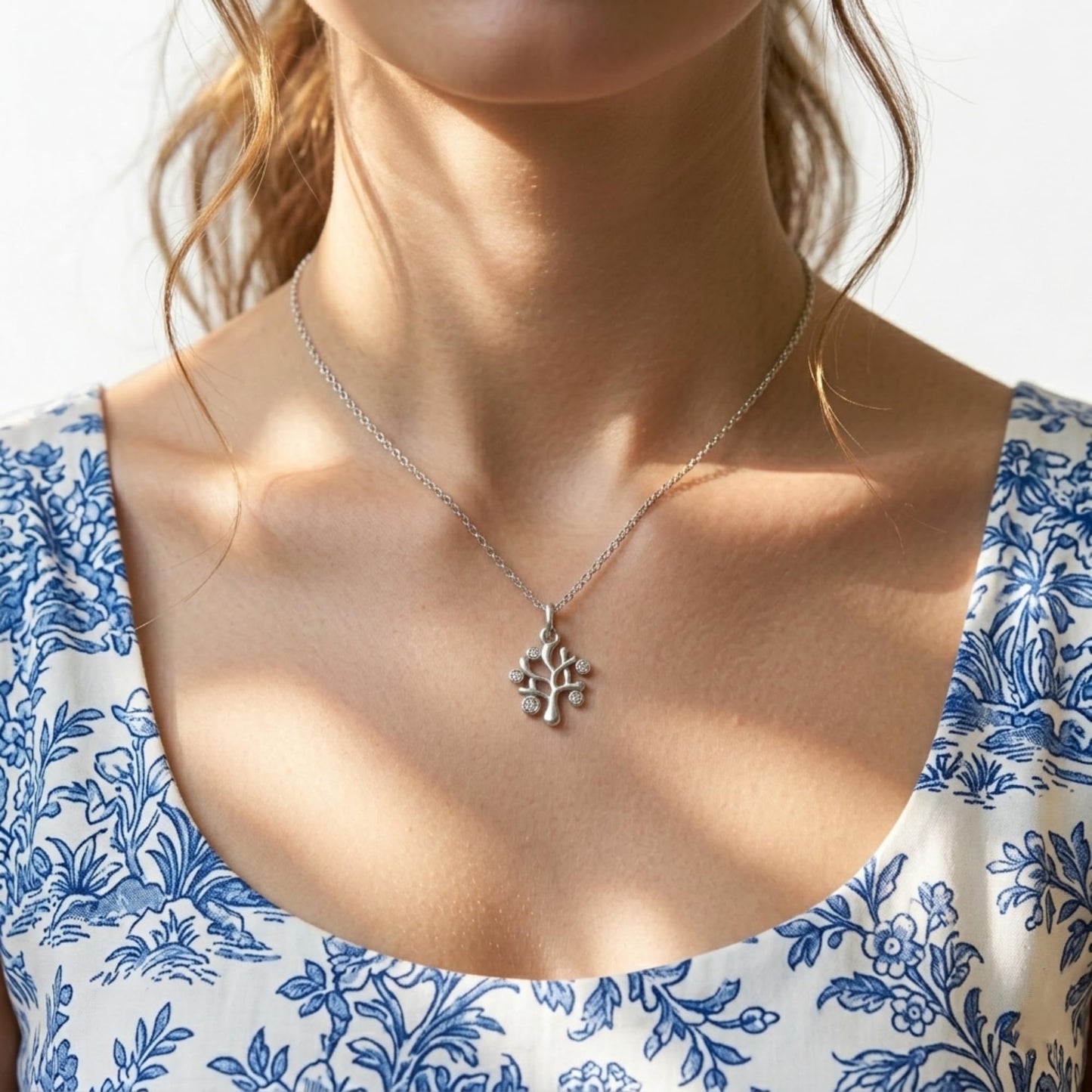 Silver tree-of-life charm necklace with small pendant on chain