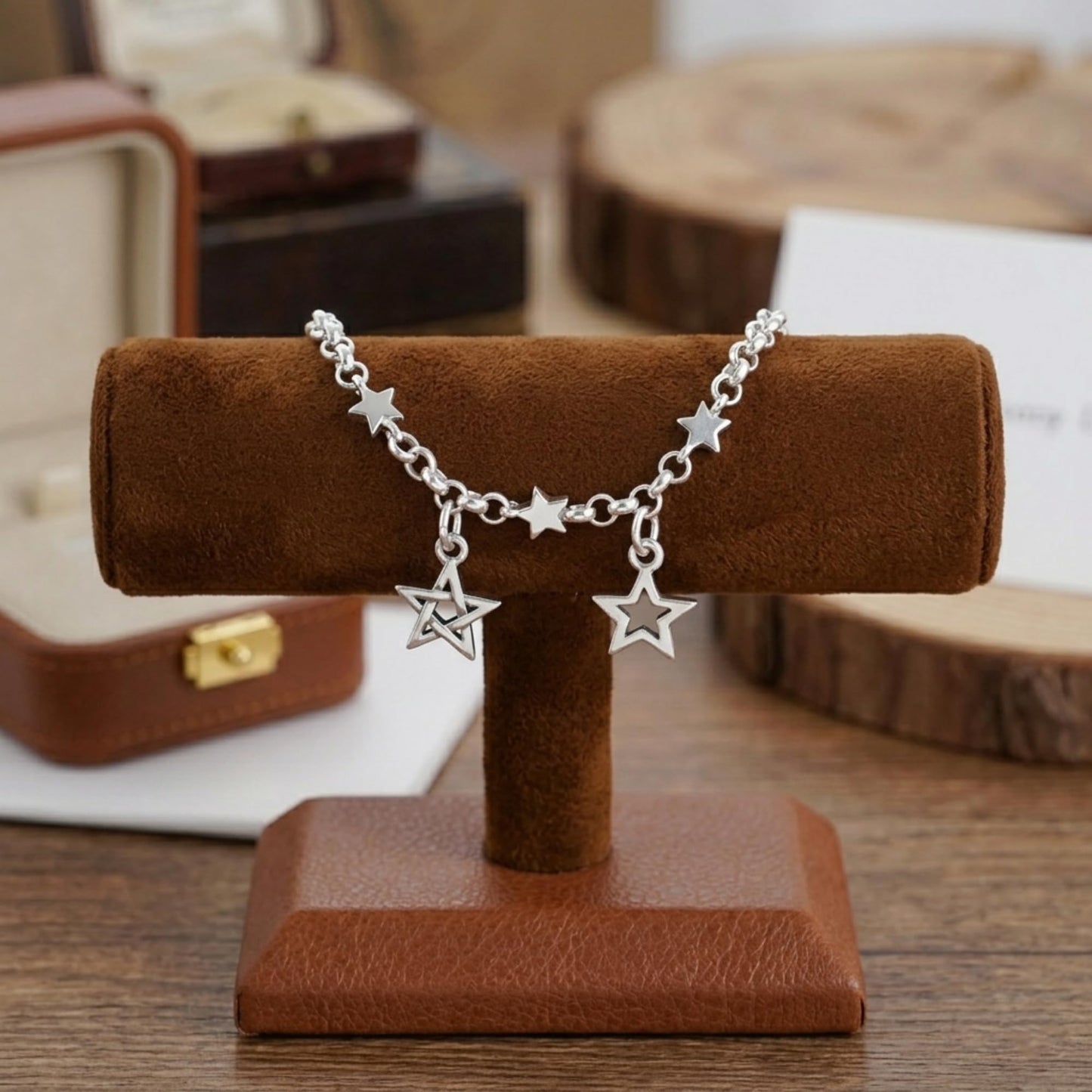 Silver star charm bracelet with two dangling hollow star charms