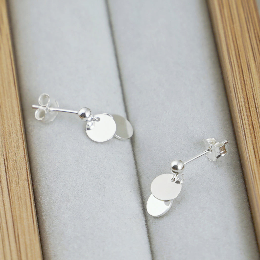 Silver-tone double-disc drop earrings with ball stud tops and two stacked round charms.