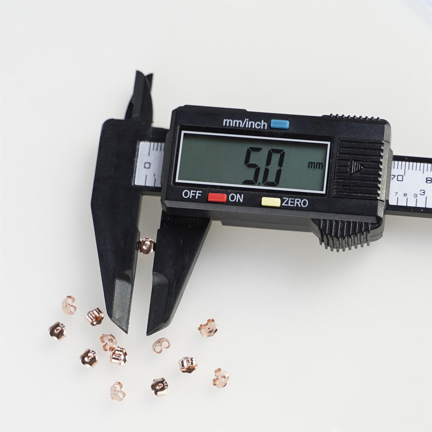 Rose gold butterfly earring backs, 5mm size shown with caliper measurement