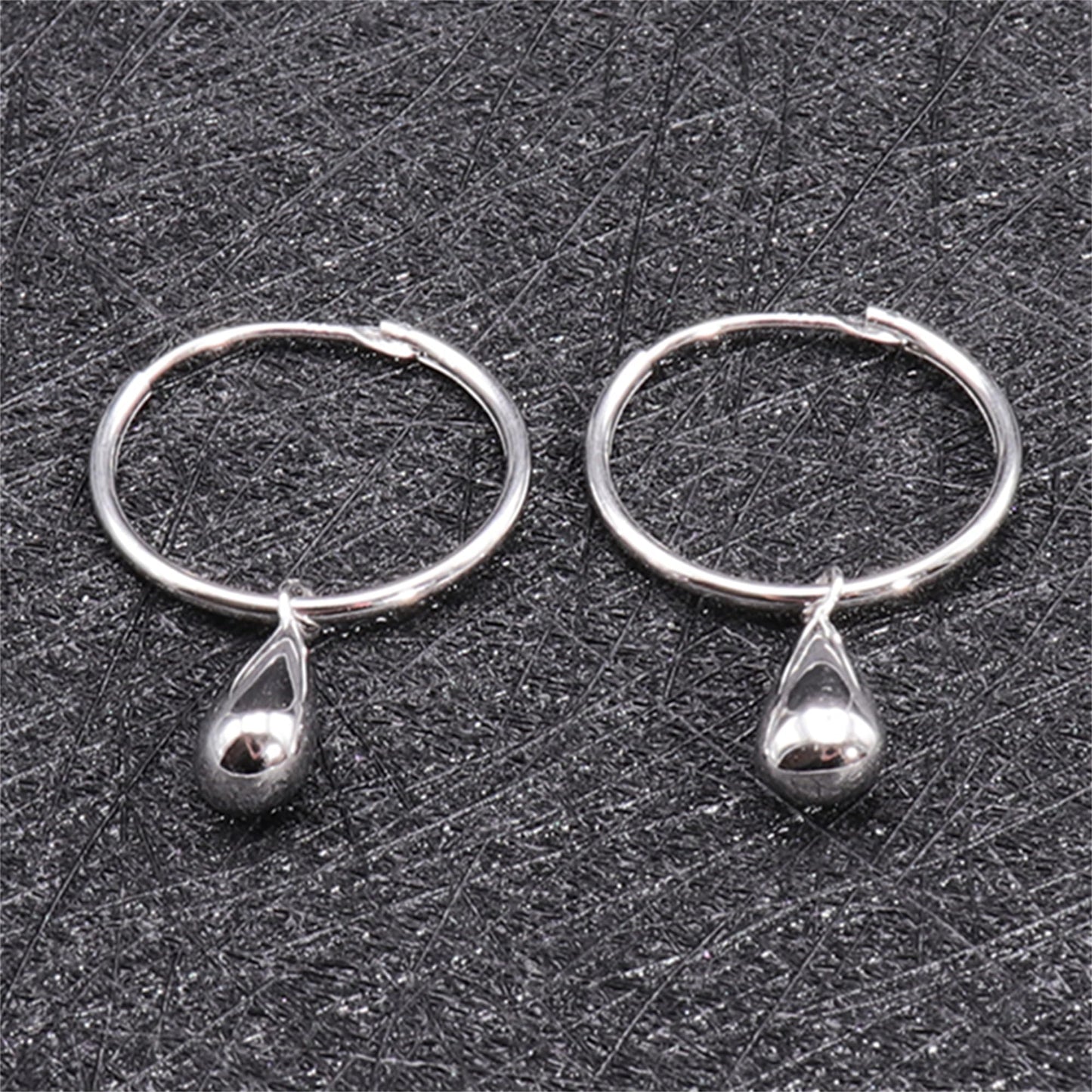 Silver teardrop hoop earrings, close-up showing hoop and teardrop charm