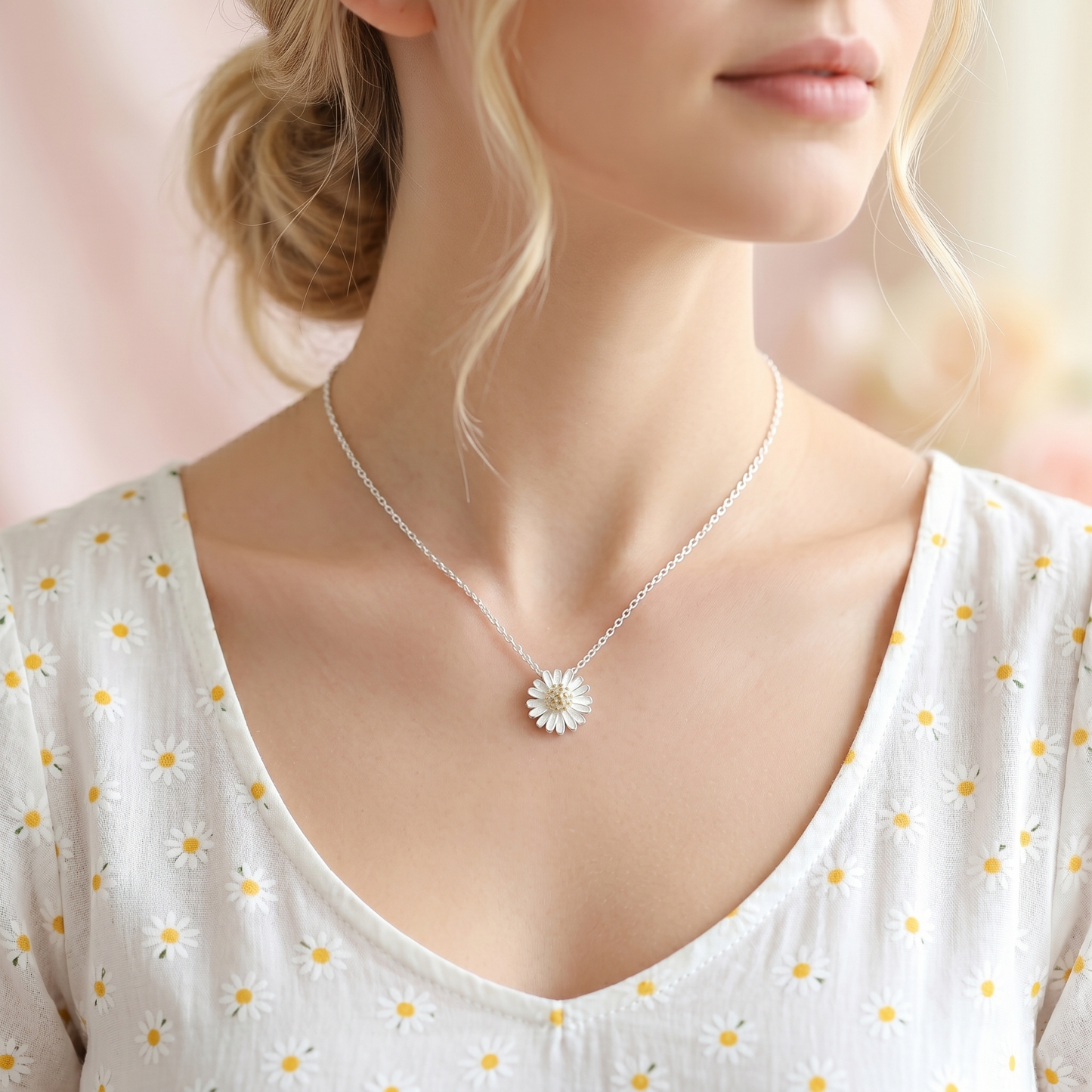Silver daisy necklace with small white flower pendant worn at the neckline