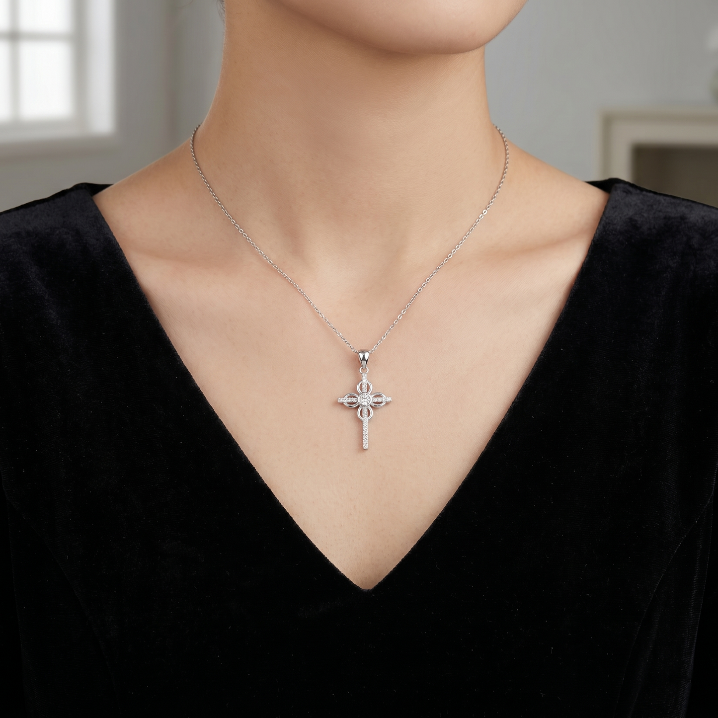 CZ cross pendant necklace centered at the collar on a silver chain