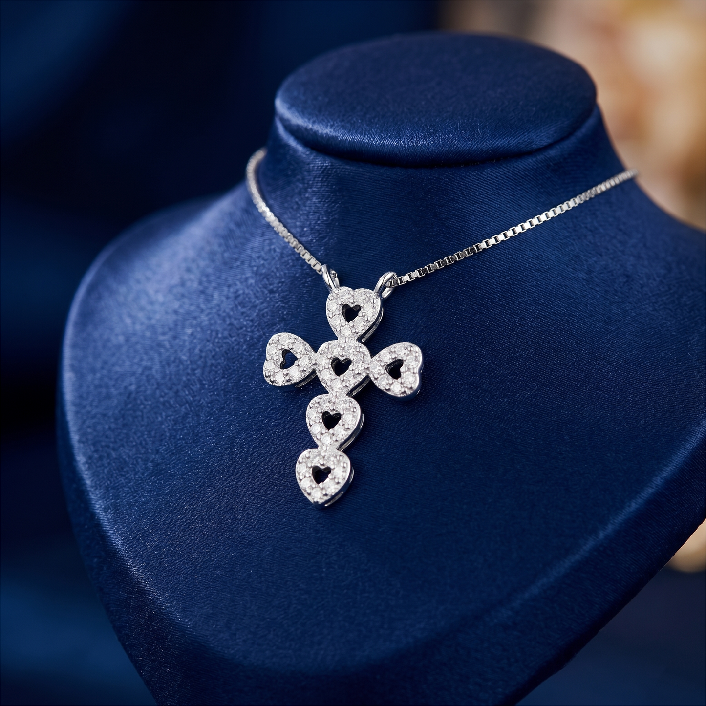Heart cross CZ necklace pendant detail with heart-shaped CZ charms on chain.