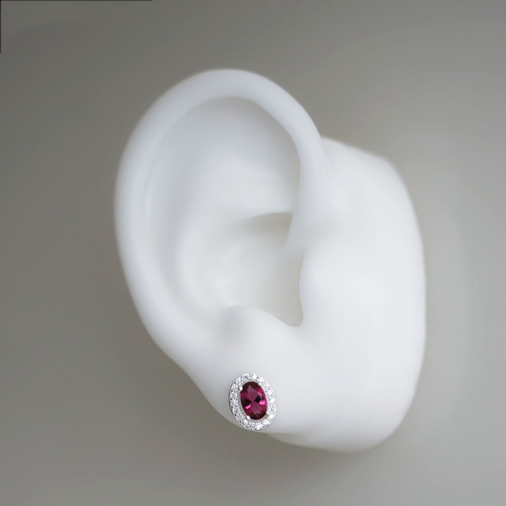 CZ halo stud earring, oval ruby red gem with silver crystal surround