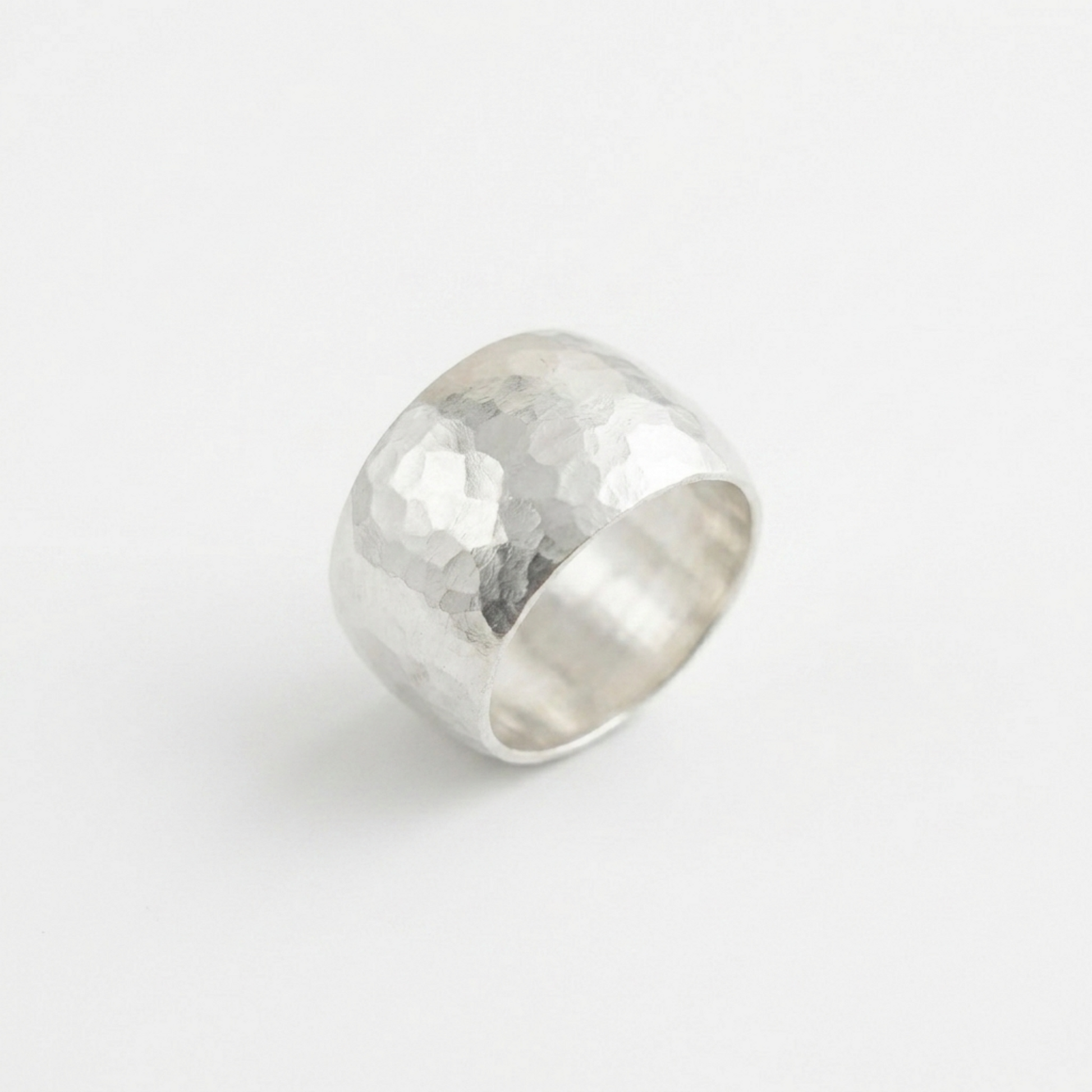 Hammered Wide Dome Ring, angled view: wide domed face with hammered pattern