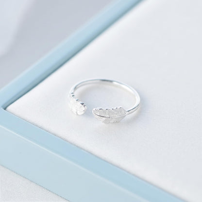 Silvertone open band ring with two small feather wings, curved for finger fit