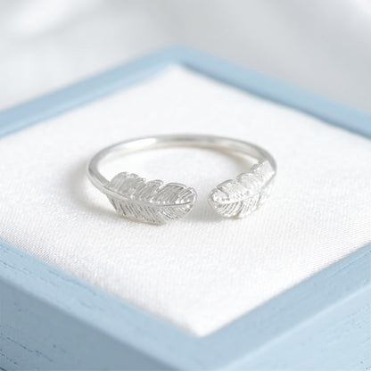 Silvertone open band ring with two embossed feather wings facing outward