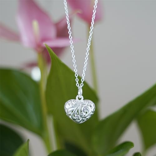 Heart pendant on necklace chain, hanging with floral motif