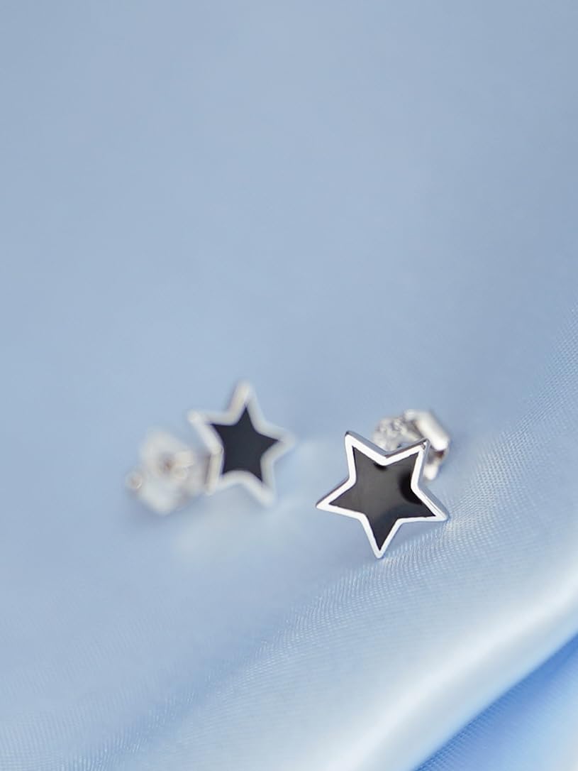 Pair of black star stud earrings with silver outline and visible post back