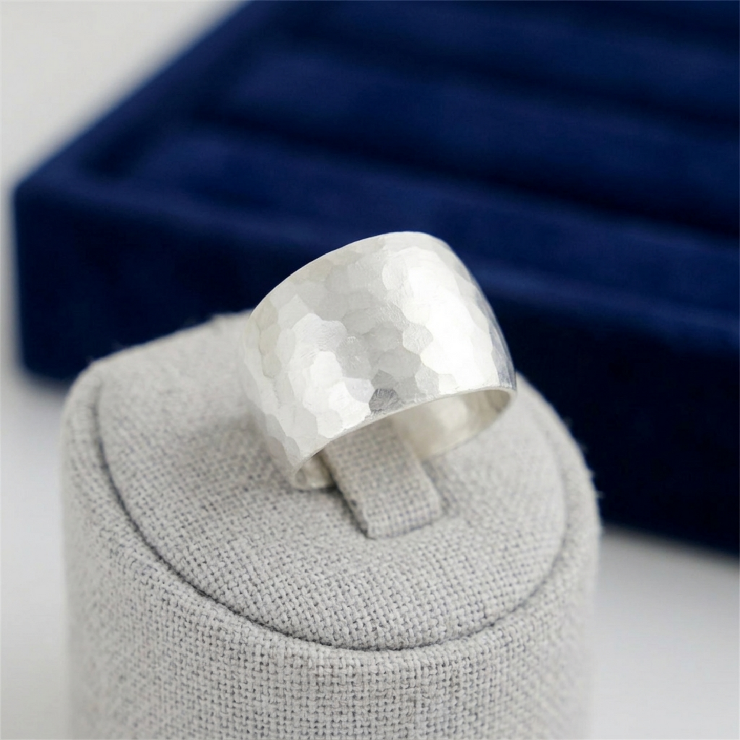 Hammered Wide Dome Ring, close-up: faceted hammered dome top on wide band