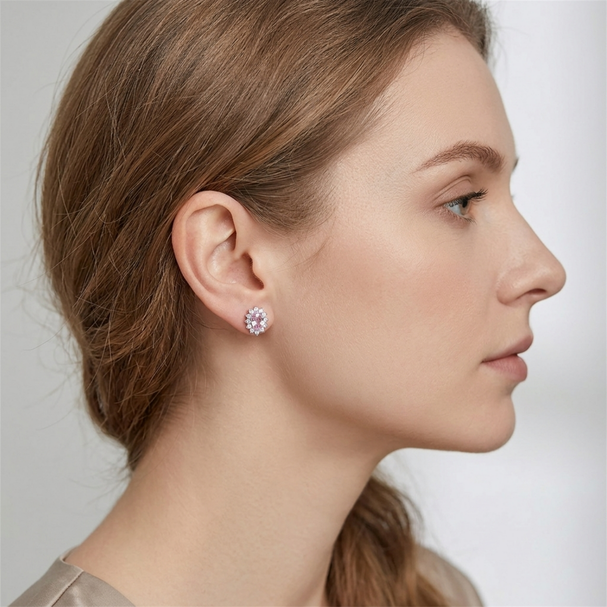 Pink oval gemstone cluster stud earrings worn on ear