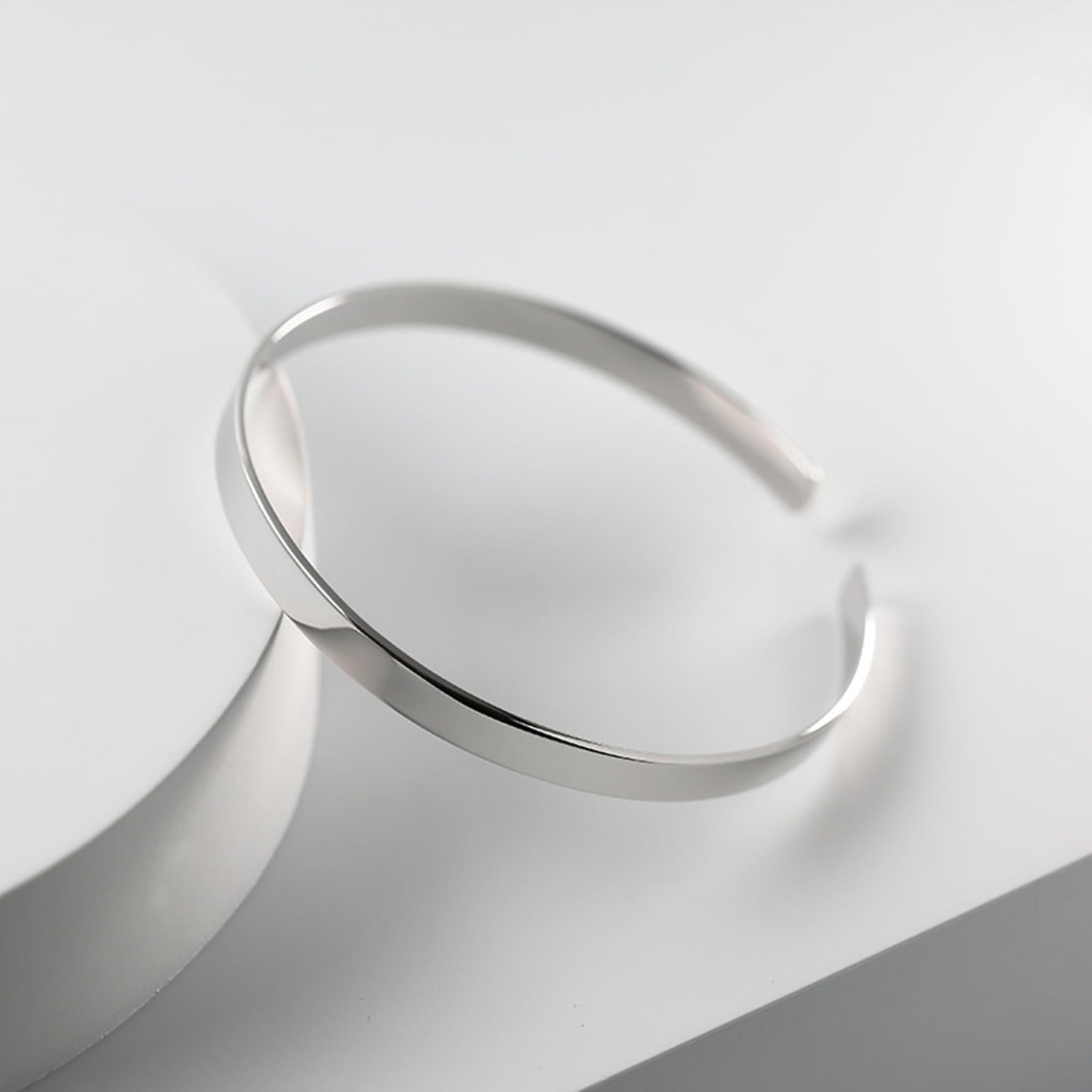 Polished cuff bangle, sleek silver band with slightly open cuff opening