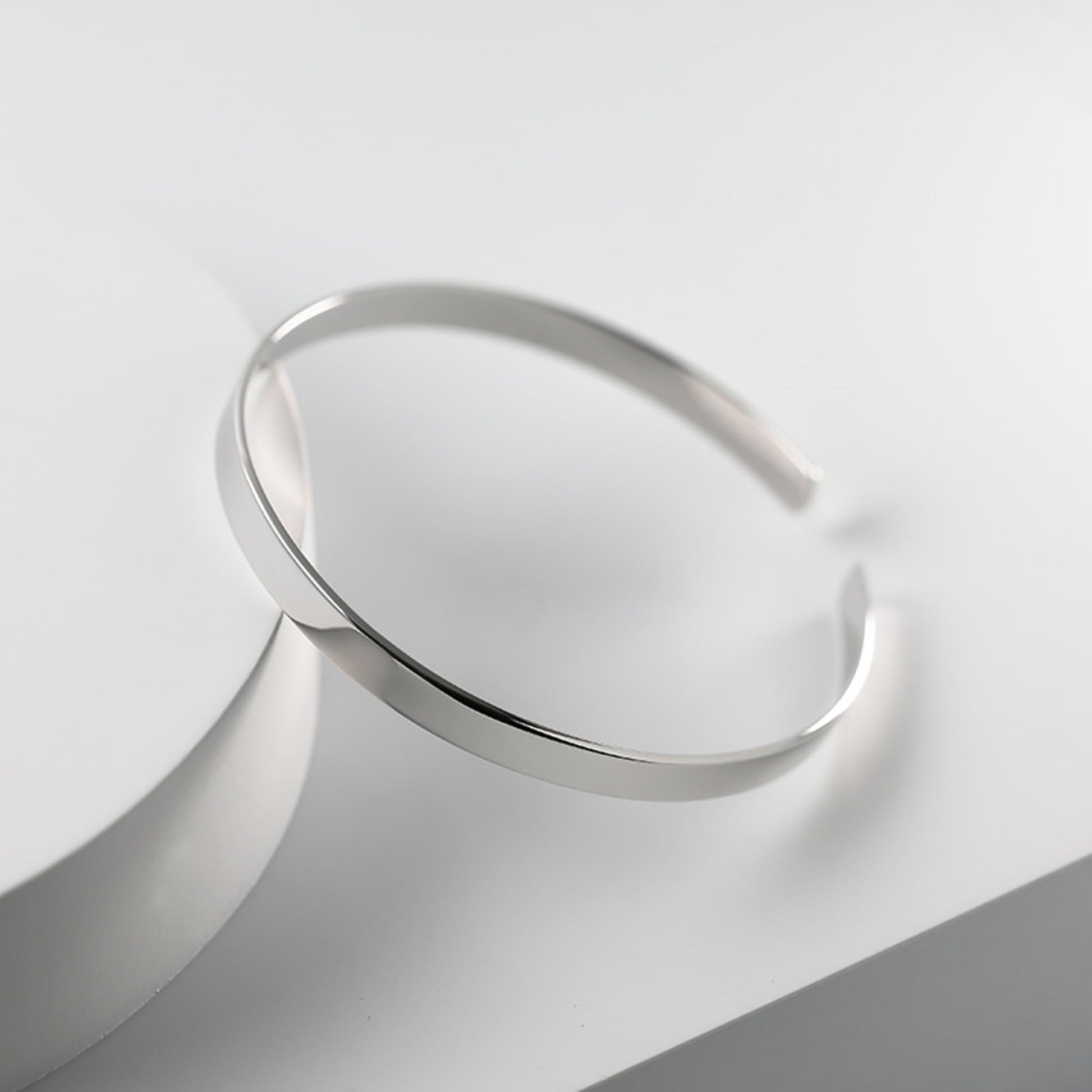 Polished cuff bangle, sleek silver band with slightly open cuff opening
