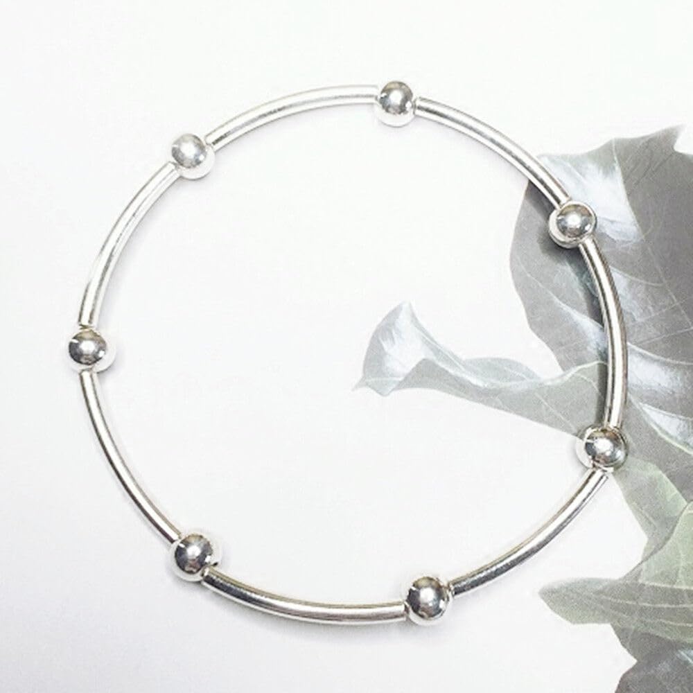 Silver bead stretch bracelet featuring spherical bead ends