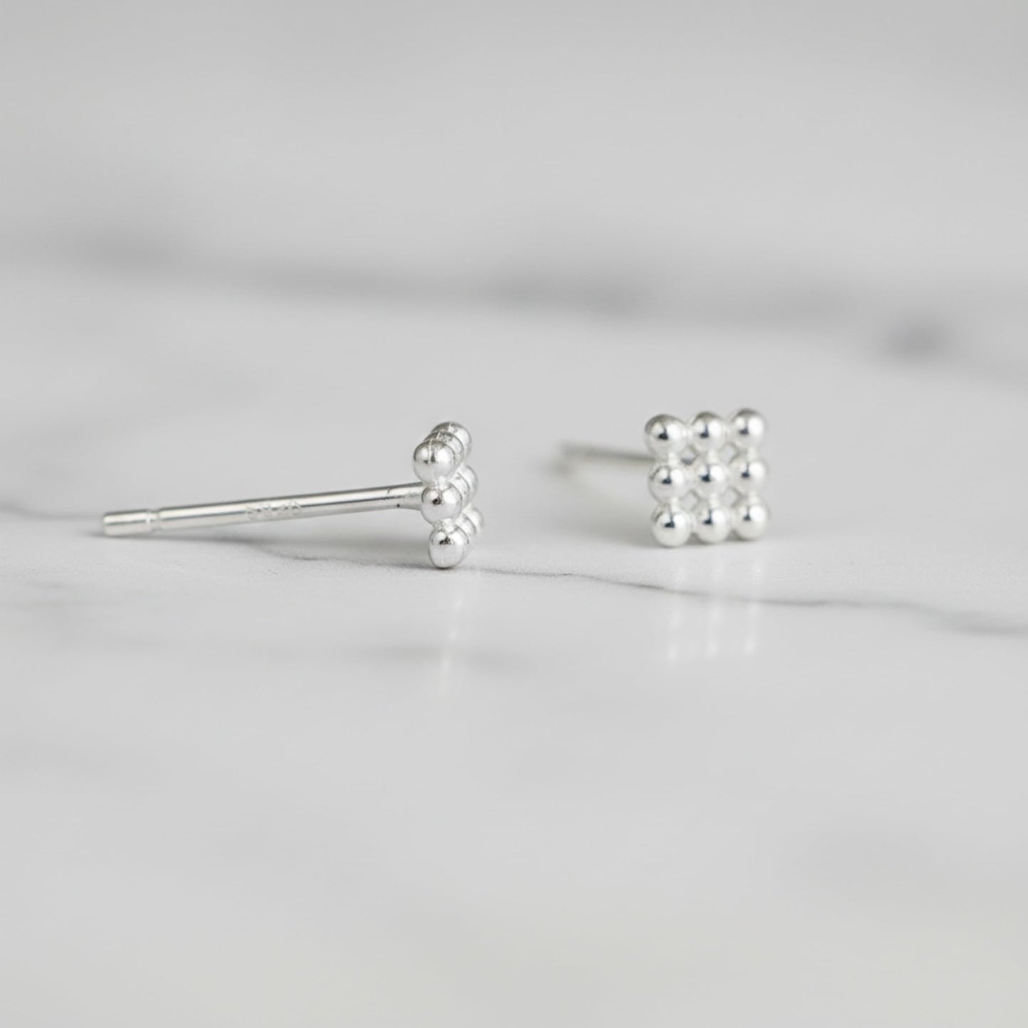 Mini geometric cube stud earrings, close-up with spherical bead details and post
