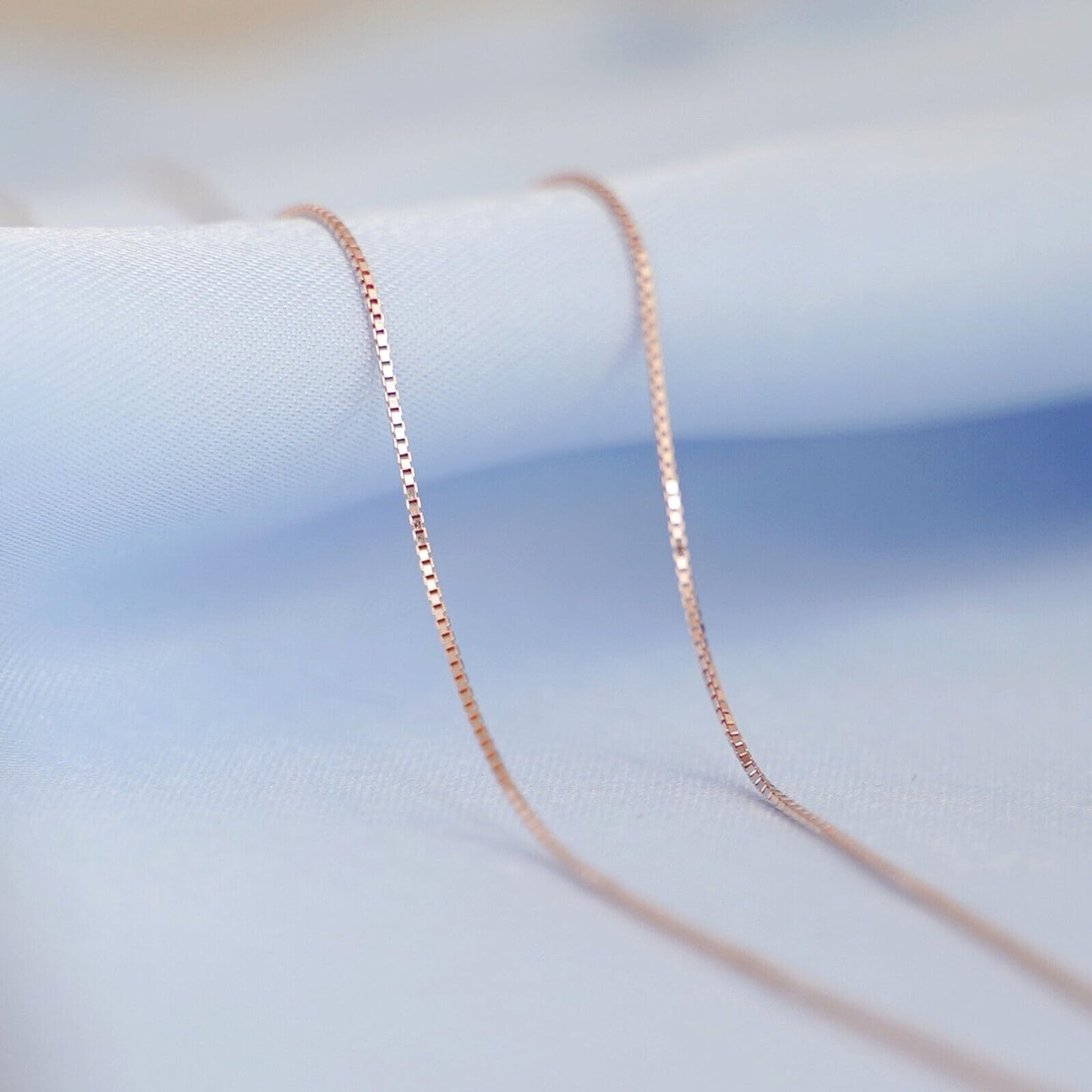 Minimalist Box Chain in Rose Gold tone, close-up of curved links