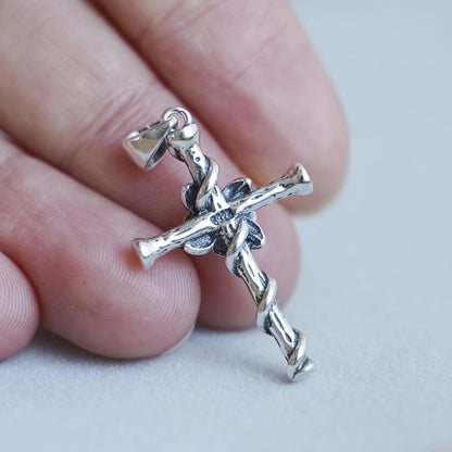 Oxidised Rose Thorn Cross pendant close-up on chain, cross arms with rose and thorn motifs