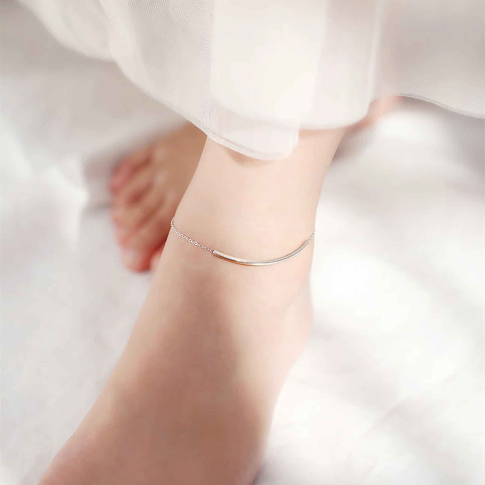 Curved Tube Curb Anklet worn on foot, curved metal tube bar on silver-tone chain