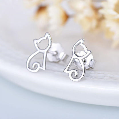 Close-up of cat outline stud earrings, polished silver cat silhouette