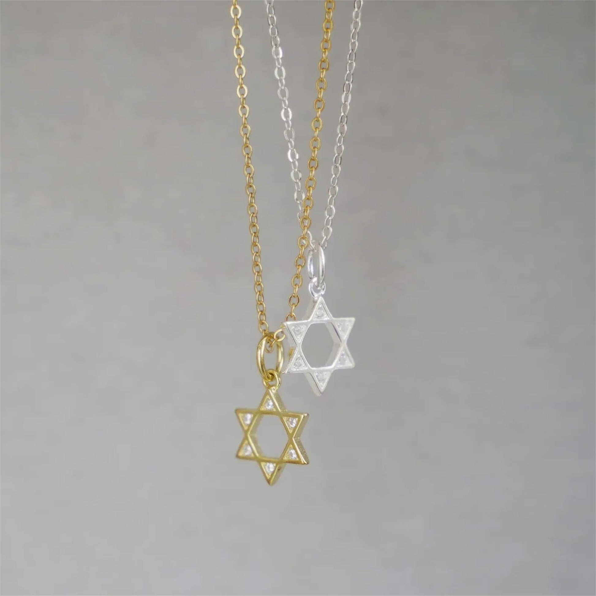 Gold and silver Star of David necklace pendants on linked chains