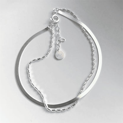Layered snake bead bracelet showing clasp end and dangling round charm