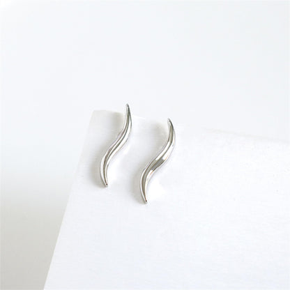 Wavy vine climber stud earrings, side view showing curved metal wave and post