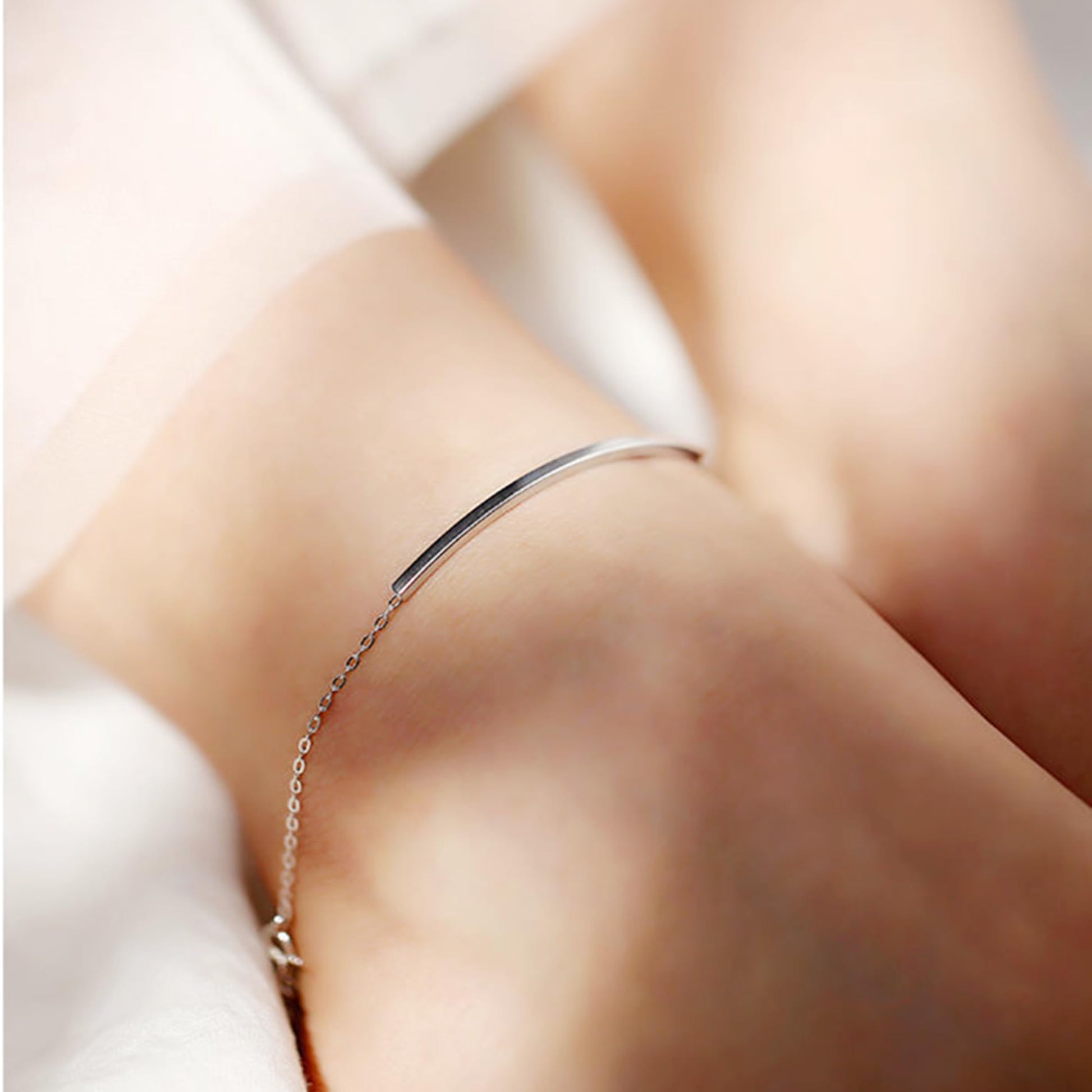 Curved Tube Curb Anklet worn on ankle: silver-tone curb chain with curved tube bar