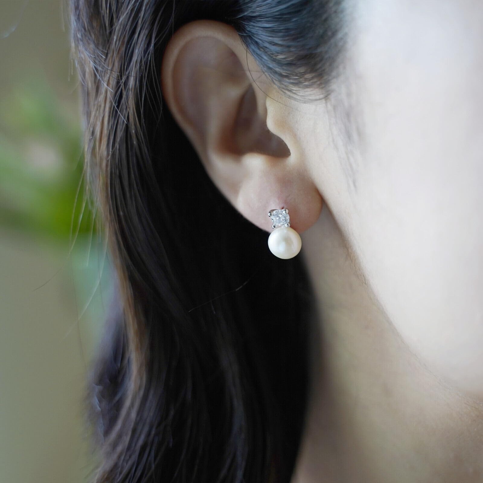 Freshwater Pearl & CZ stud earrings on model: white pearl drops with round CZ centers