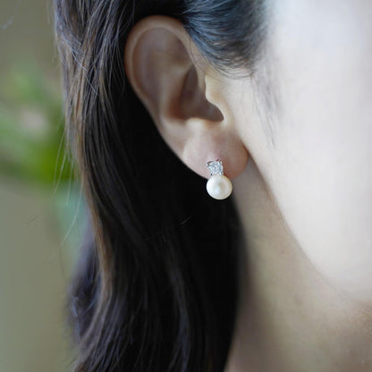 Freshwater Pearl & CZ stud earrings on model: white pearl drops with round CZ centers
