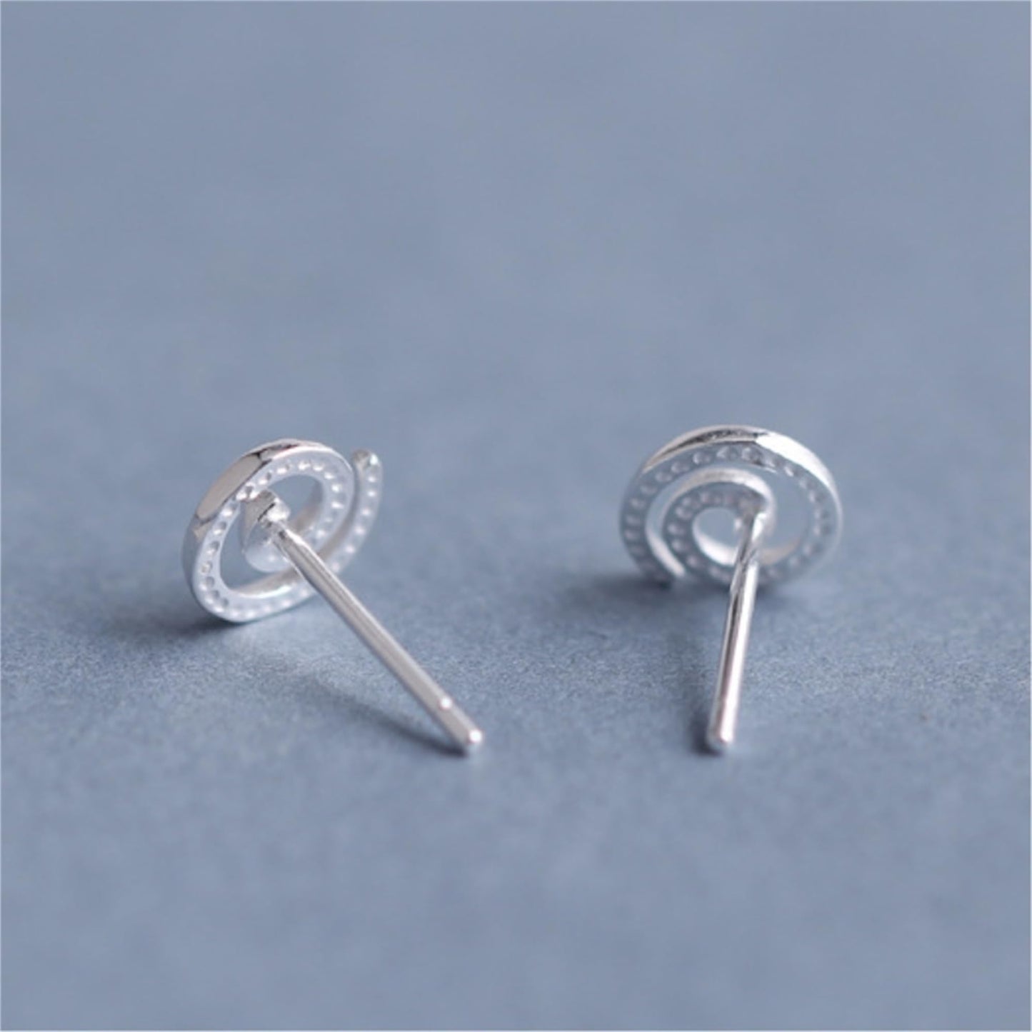 Spiral Swirl Studs earrings showing front swirl and straight post backing