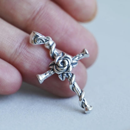 Oxidised Rose Thorn Cross pendant close-up, twisted cross with raised rose and thorn accents