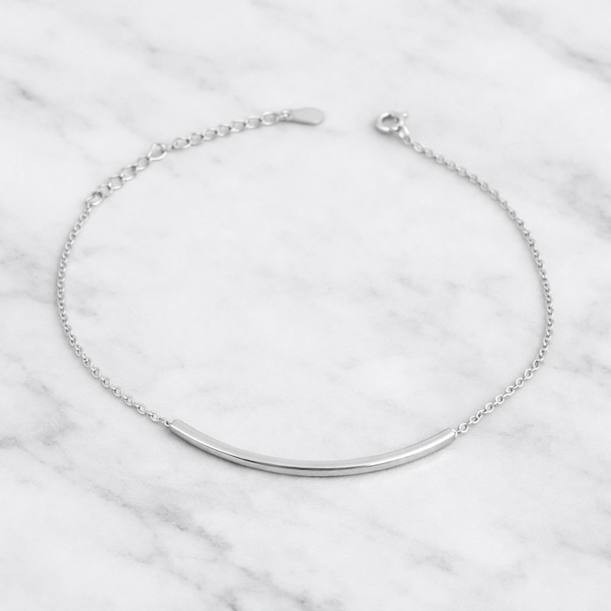 Curved Tube Curb Anklet featuring curved metal tube bar and curb chain with clasp