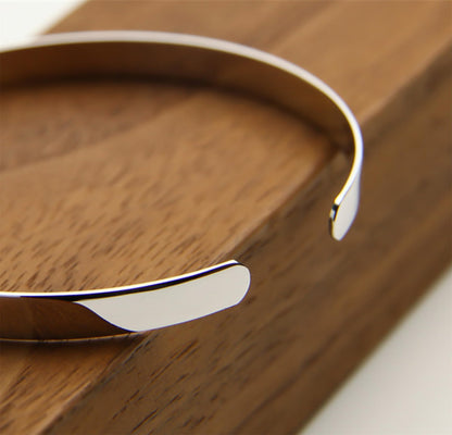 Close-up of polished silver cuff bangle ends and smooth hinge opening