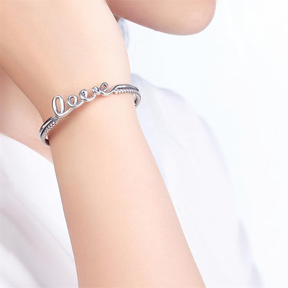Love Knot Rope Cuff bracelet on wrist, silver-tone with 'Love' script