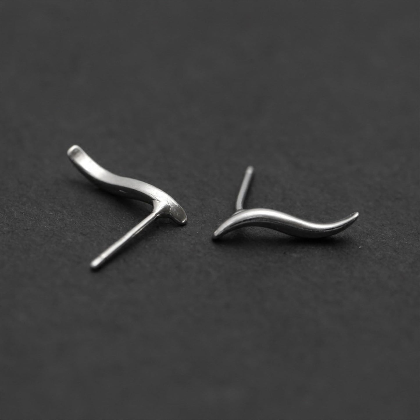 Wavy vine climber stud earrings, front view of two curved waves with post details