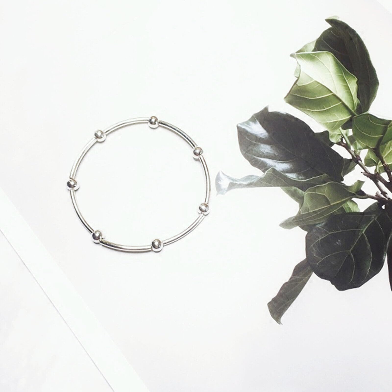 Silver round bead stretch bracelet on a wrist