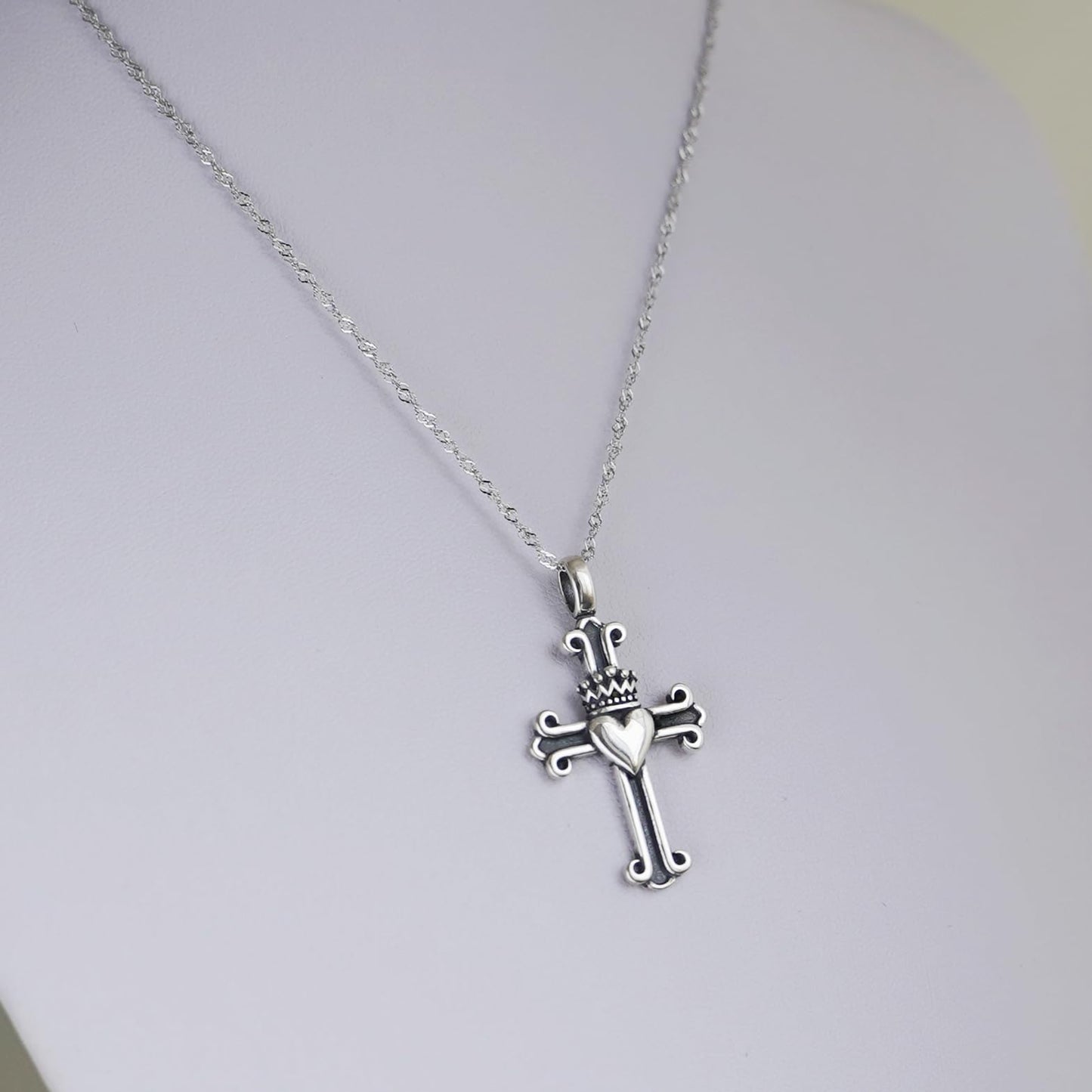 Rhodium twisted chain with metallic cross pendant