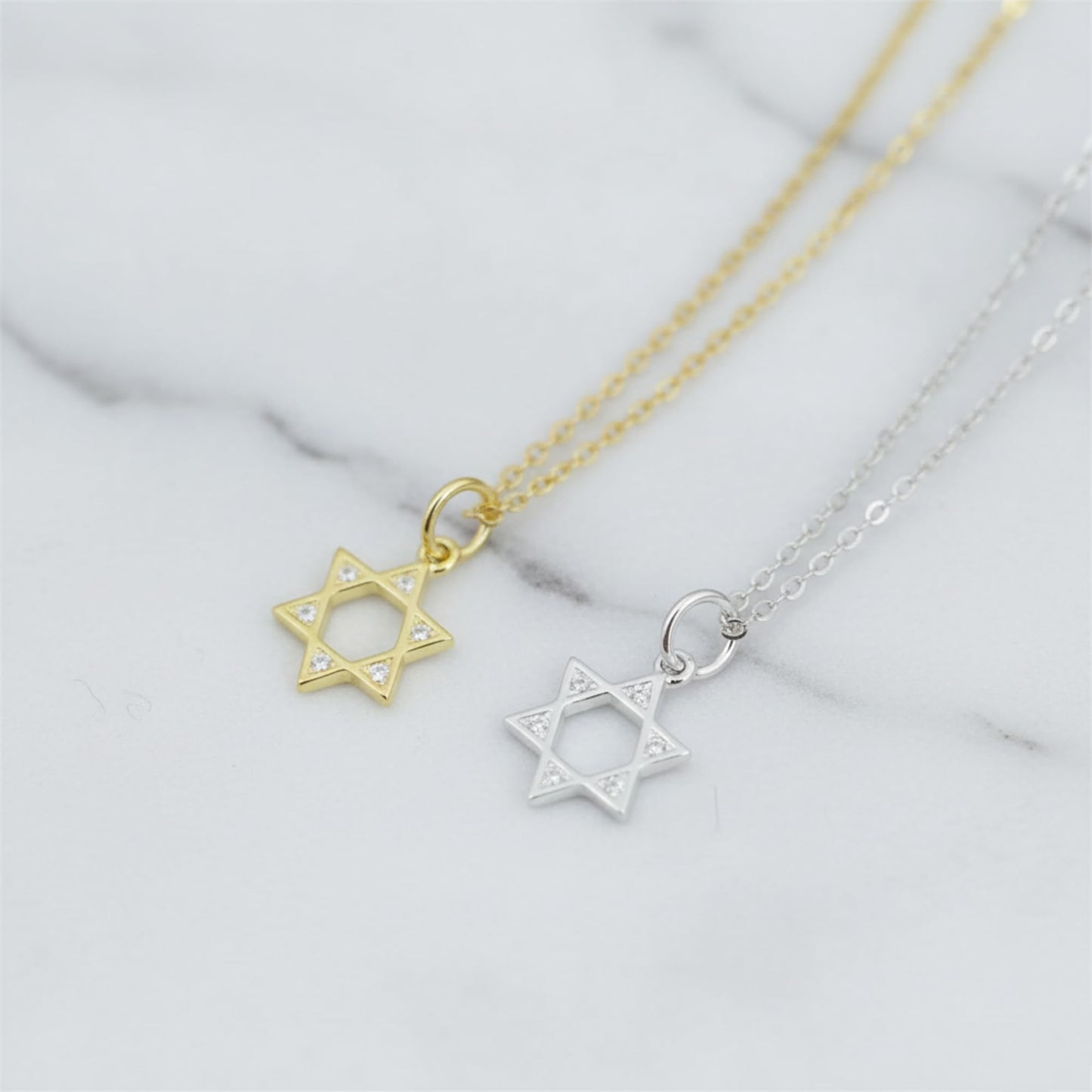 Gold-tone and silver-tone Star of David necklace pendants on thin chains