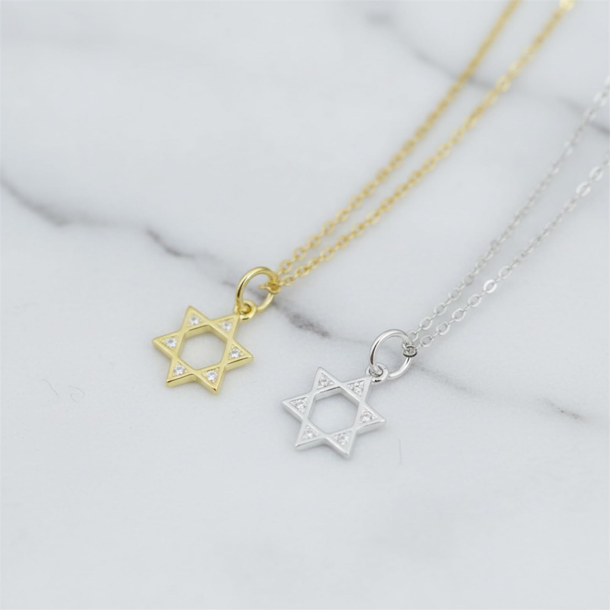 Gold-tone and silver-tone Star of David necklace pendants on thin chains