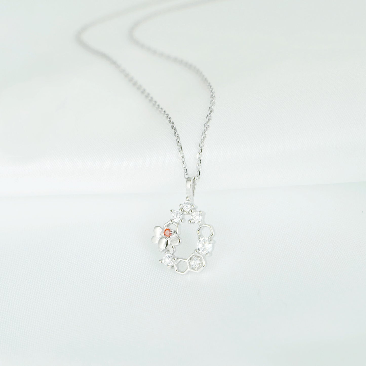 Silver-tone honeycomb necklace pendant with bee and sparkling hexagon charms