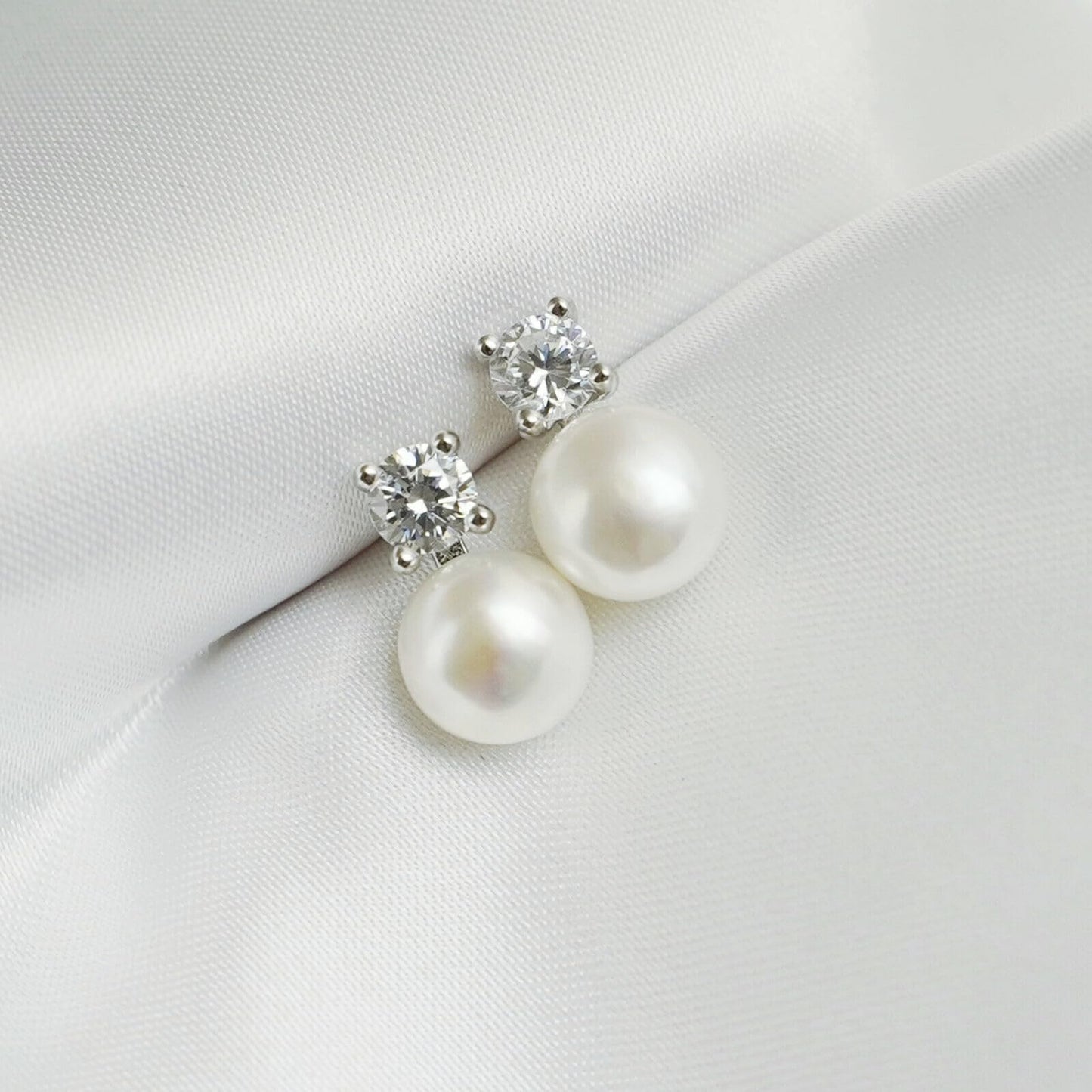Freshwater Pearl & CZ stud earrings, small round CZ and white pearl drops, angled view