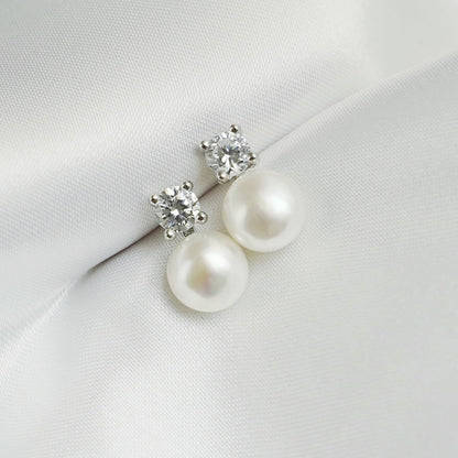 Freshwater Pearl & CZ stud earrings, small round CZ and white pearl drops, angled view
