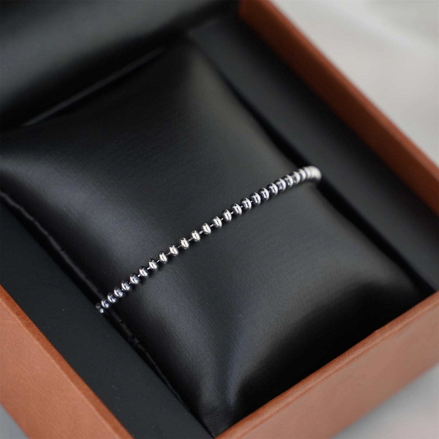 Oxidised flat bead bracelet straight-on view of silver-toned round beads