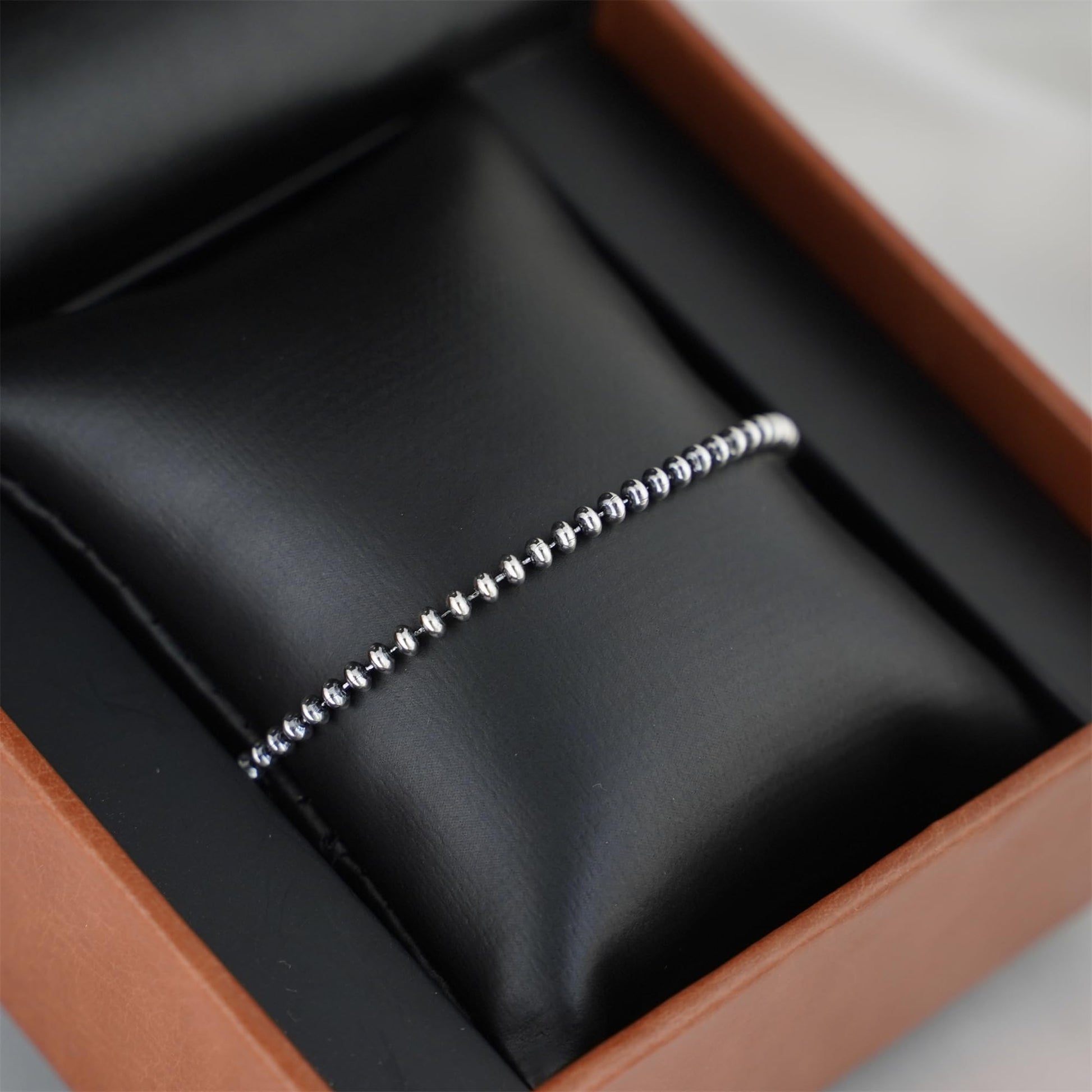 Oxidised flat bead bracelet straight-on view of silver-toned round beads