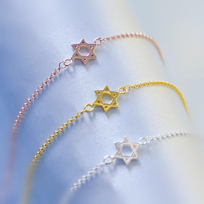 Star of David bracelets in rose, gold, and silver, each with a star charm.