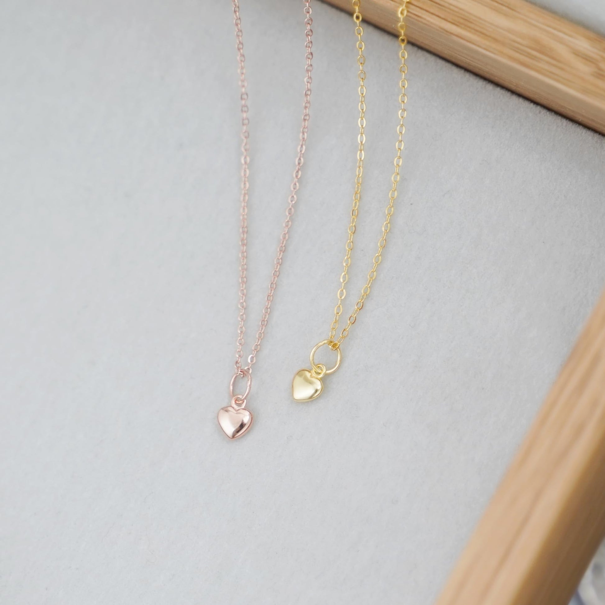 3-Tone Mixed Link Chain with heart charms on rose gold, silver, and gold-tone chains