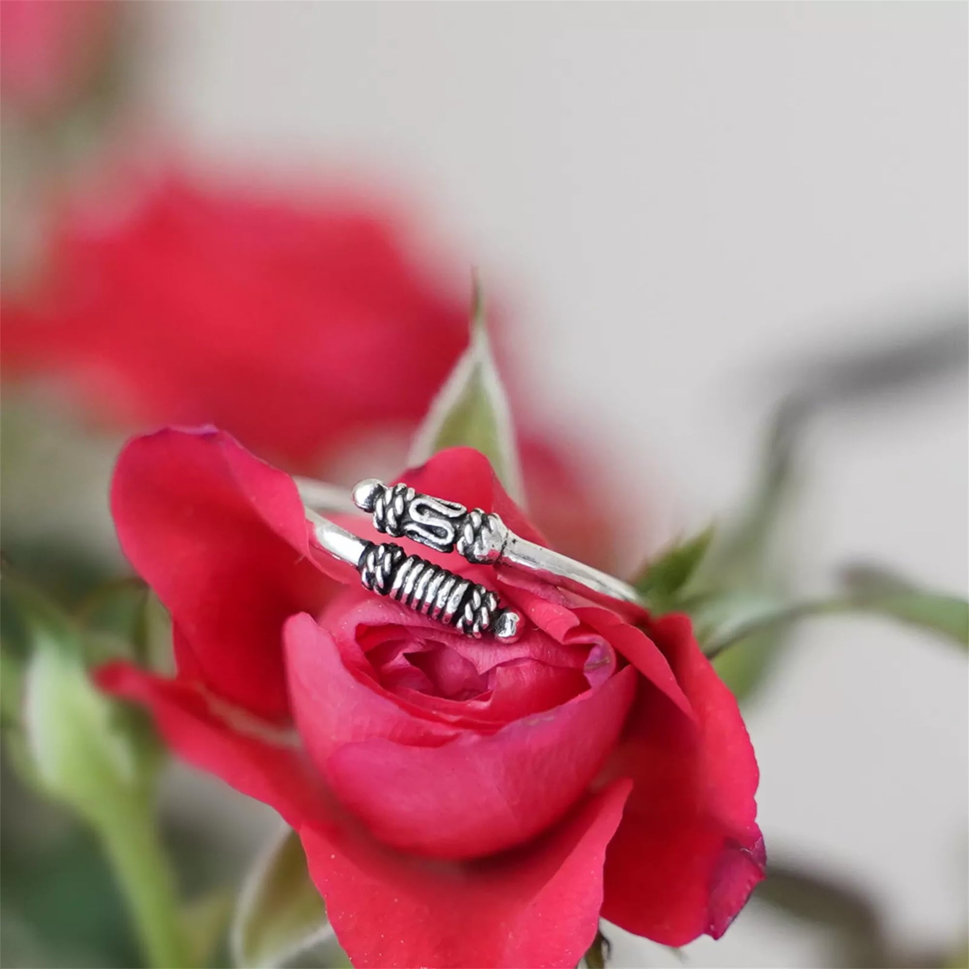 Oxidised Totem Knot ring on finger, silver tone with raised knot and braided ridge