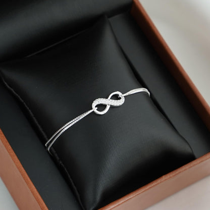 CZ Infinity bracelet: textured infinity link with small round clasp and extender chain