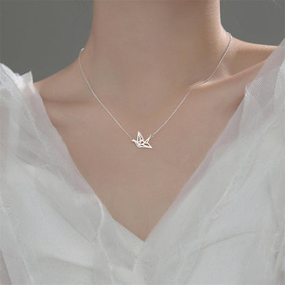 Silver origami crane pendant necklace, V-shaped crane charm at neckline